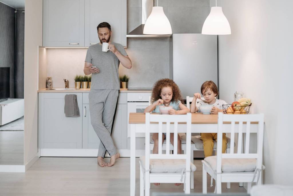 man and children eating healthy breakfast