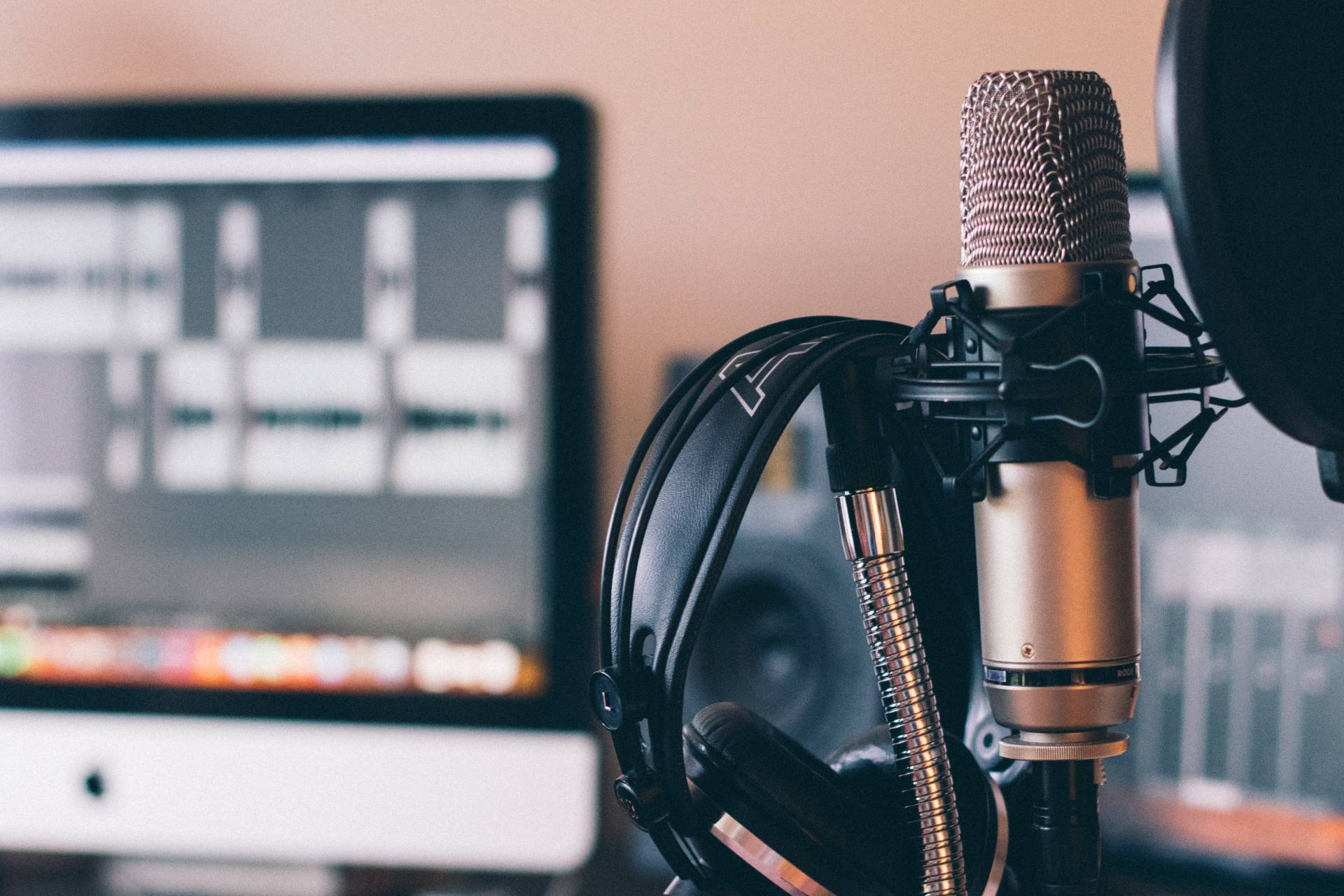 microphone and headset in front of a computer screen; create a podcast