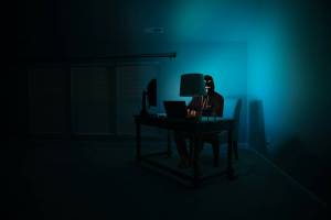 a man coding in a dark room
